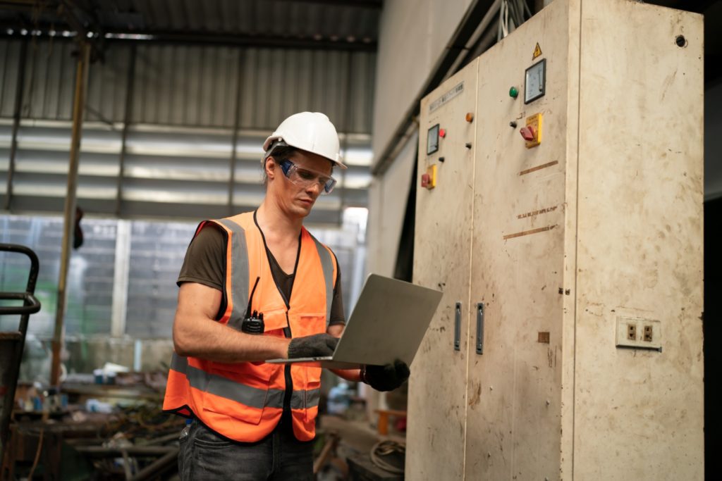 Metal industry worker at factory in work wear