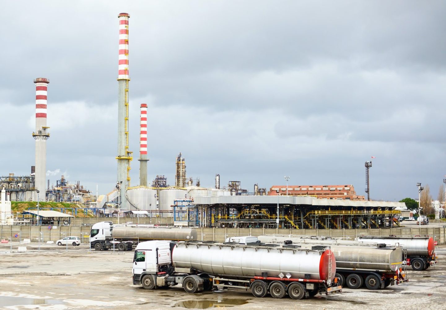 Oil refinery industry, smoke stacks and tanker lorry or truck